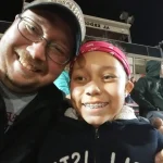 Rianna and her father catching a Northampton Powderpuff football game.