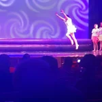 Rianna getting ready to perform a dance move in her last recital.