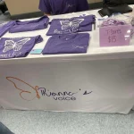 Our table with a few t-shirts displayed at the Breaking the Silence Mystery Bingo.