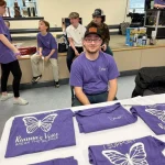 One of our volunteers helping us with our awareness t-shirts.
