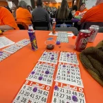 Checking out the bingo cards of some players during the Breaking the Silence Mystery Bingo.