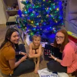 Rianna and her siblings hanging out by the Christmas tree.