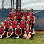 Rianna and her softball team posing after a game.