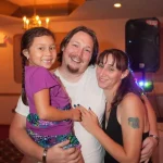 Rianna with her father and stepmother at a family wedding.