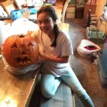 Rianna carving her pumpkin.