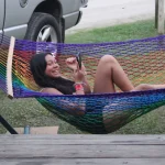 Rianna lounging in the hammock while on vacation.