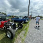 Photo of a few older cars at the car show.